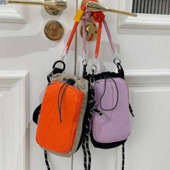 JE Compact Nylon Drawstring Mini Crossbody Bag with Color … in Singapore - Image 1